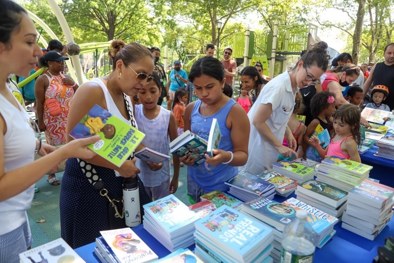 Families choosing free books at a free book festival